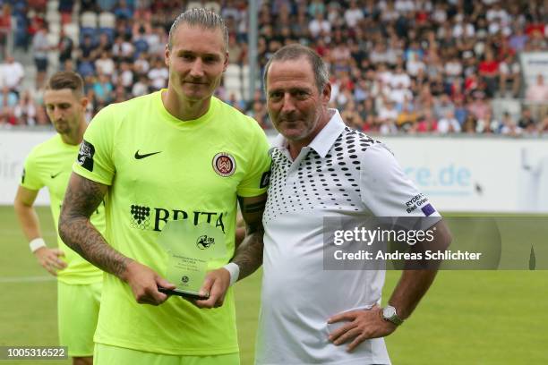 Torschützenkoenig Manuel Schaeffler of SV Wehen Wiesbaden is presented with an award by Uwe Bein for scoring the most goals in the 3rd league during...