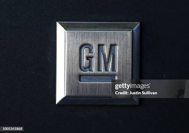 The General Motors logo is displayed on a car a Chevrolet dealership on July 25, 2018 in Colma, California. General Motors lowered its profit...