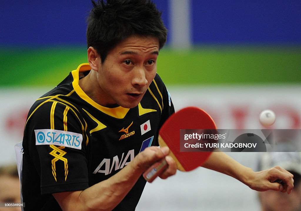 Kaii Yoshida of Japan returns a service