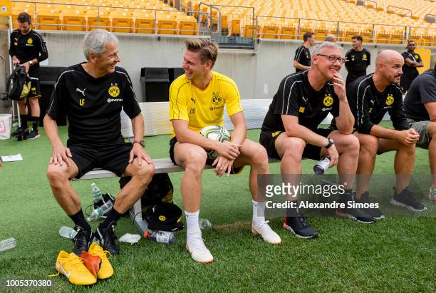 Lucien Favre, head coach of Borussia Dortmund talks with Lukasz Piszczek during training session at Hein Field stadium as part of Borussia Dortmund...