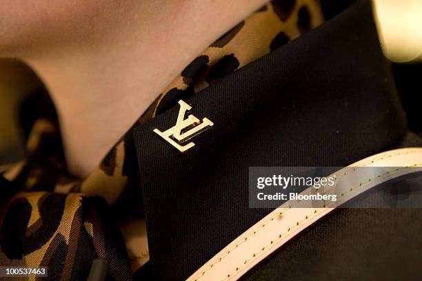 Louis Vuitton employee wears a lapel badge at the LVMH Moet Hennessy Louis Vuitton SA "maison" store in New Bond Street in London, U.K., on Tuesday,...