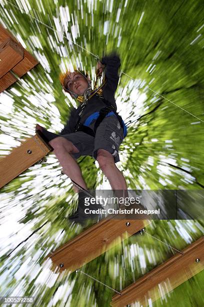 Young clkimber in action during a climbing session at the GHW tightrobe climbing garden on May 25, 2010 in Hueckeswagen, Germany.