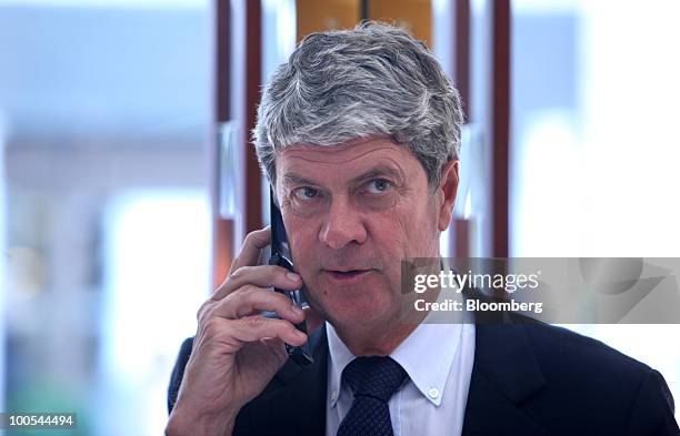 Yves Carcelle, chief executive officer of Louis Vuitton, speaks on his mobile phone at the Louis Vuitton "maison," the flagship store for LVMH Moet...