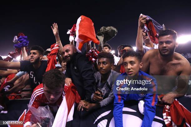 Fans are seen as Mohammed Salah of Liverpool FC signs fan jerseys at the end of a friendly match between Manchester City and Liverpool FC within the...