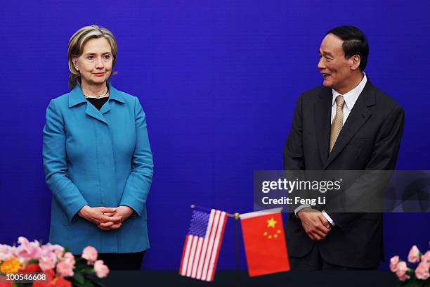 Secretary of State Hillary Clinton and China's Vice Premier Wang Qishan stand up after a press conference for the China-U.S. Strategic and Economic...