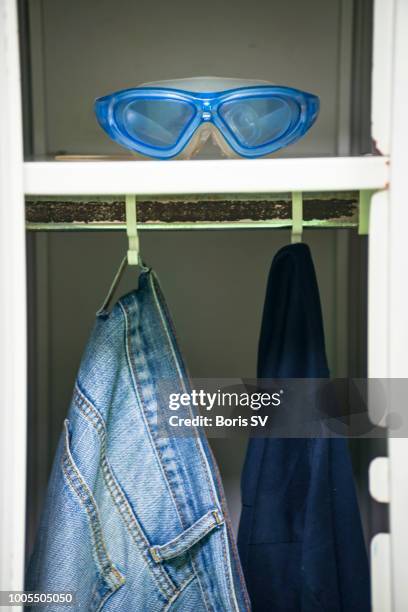 swimming goggles in men's locker - sports equipment locker stock pictures, royalty-free photos & images