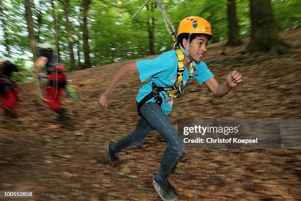 Climber Benny runs during a climbing session at the GHW tightrobe climbing garden on May 25, 2010 in Hueckeswagen, Germany.