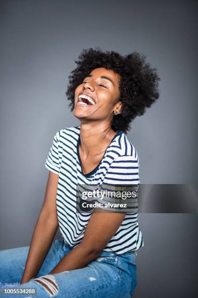 cheerful young woman sitting with eyes closed - fotografia de três quartos imagens e fotografias de stock