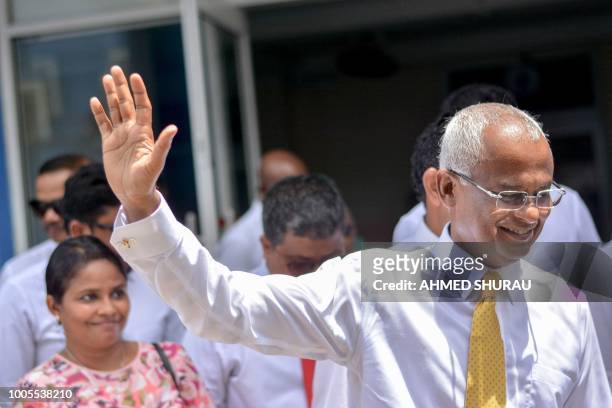 Maldivian opposition candidate Ibrahim Solih waves during a march to the Election Commission to submit his application for President along with his...
