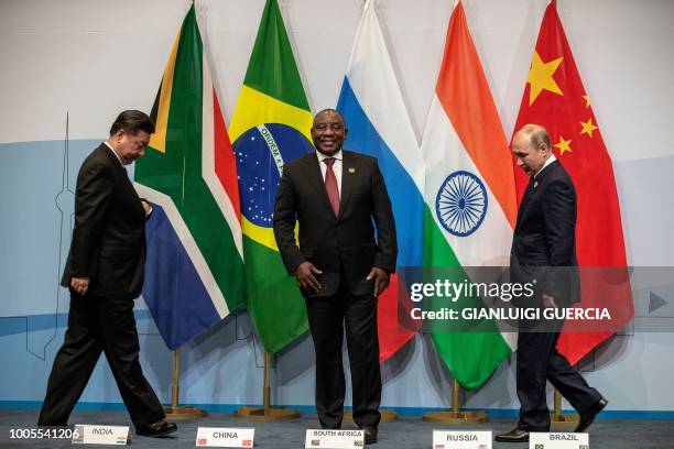 China's President Xi Jinping, South Africa's President Cyril Ramaphosa and Russia's President Vladimir Putin arrive to pose for a group picture...