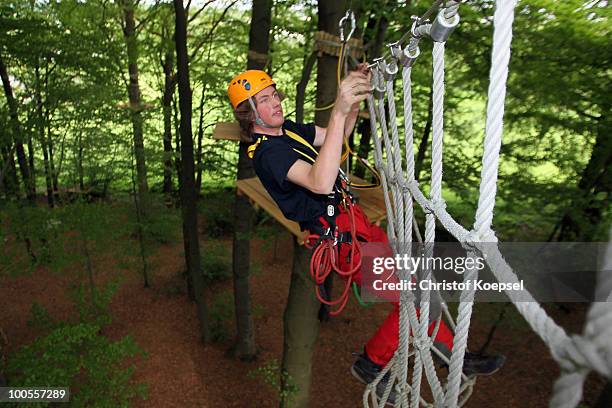 Climber Daniel in action during a climbing session at the GHW tightrobe climbing garden on May 25, 2010 in Hueckeswagen, Germany.