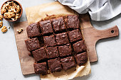 Chocolate brownie squares on cutting board, top view