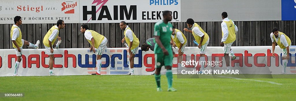 Saudi substitute players stretch during