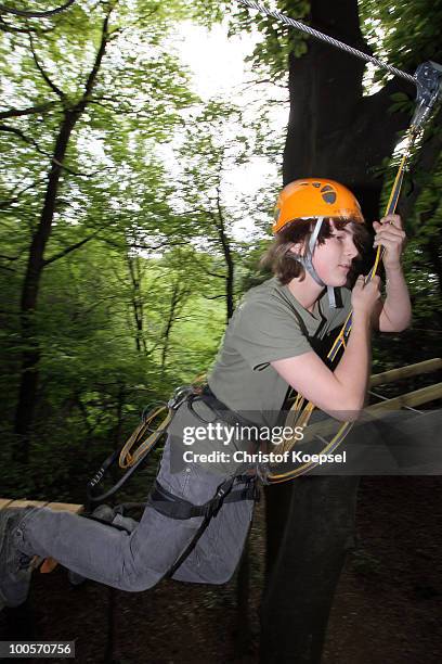 Climber Sven hangs on a rope during a cllimbing session at the GHW tightrobe climbing garden on May 25, 2010 in Hueckeswagen, Germany.