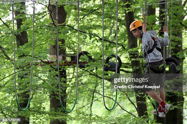 Young climber in action during a climbing session at the GHW tightrobe climbing garden on May 25, 2010 in Hueckeswagen, Germany.