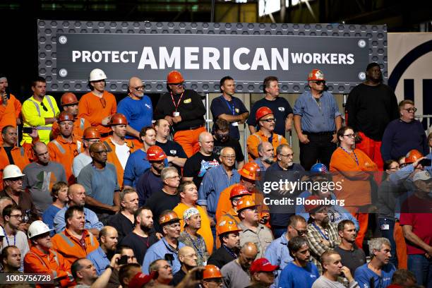 Audience members listen as U.S. President Donald Trump, not pictured, speaks at the U.S. Steel Corp. Granite City Works facility in Granite City,...