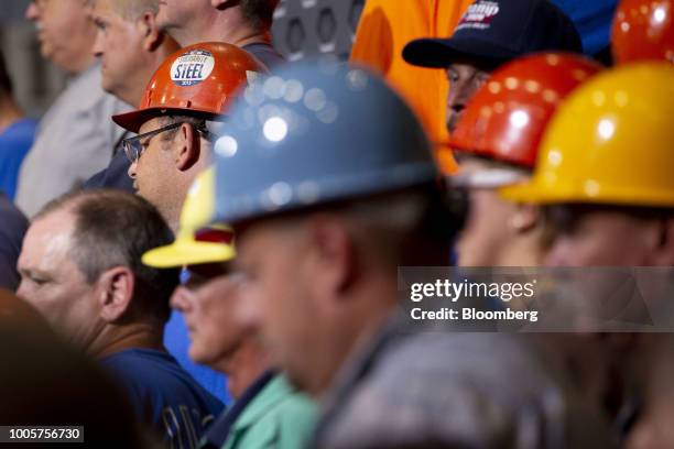 Workers listen as U.S. President Donald Trump, not pictured, speaks at the U.S. Steel Corp. Granite City Works facility in Granite City, Illinois,...