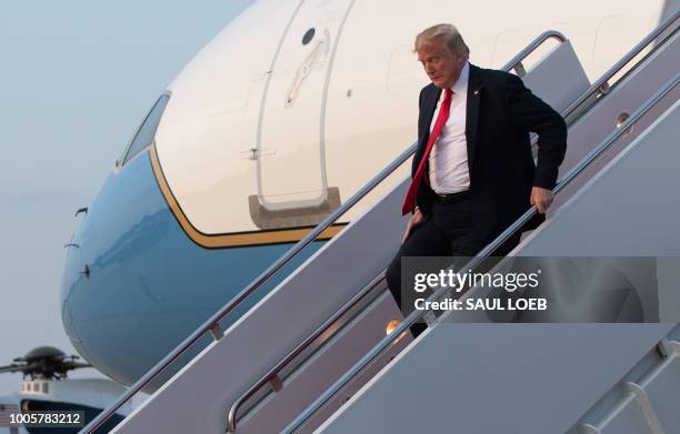 President Donald Trump disembarks from Air Force One upon arrival at Joint Base Andrews in Maryland, July 26 following a day trip to Iowa and...