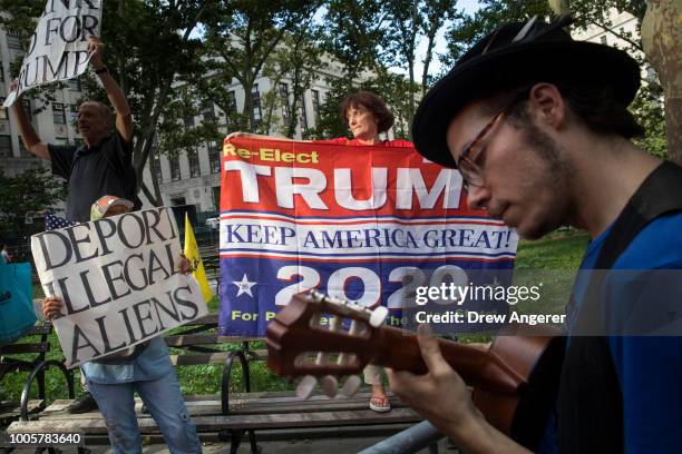 Counter-demonstrators supporting President Donald Trump rally across the street from activists rallying against the Trump administration's...