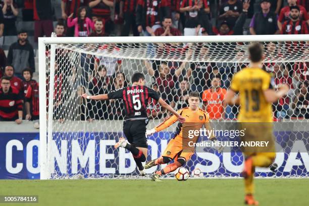 Pablo of Brazils Atletico Paranaense vies for the ball with Uruguay's Penarol goalkeeper Kevin Dawson during their 2018 Copa Sudamericana football...