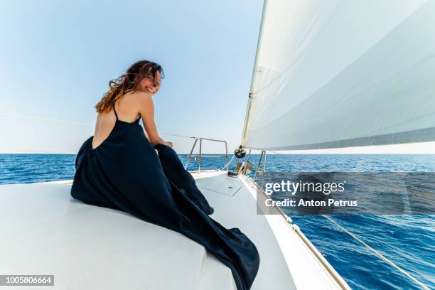 young girl in a black summer dress on a white yacht - caribbean dream stock pictures, royalty-free photos & images