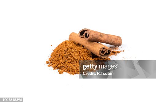 Cinnamon sticks with powder isolated on white background Cinnamon sticks with powder isolated on white background