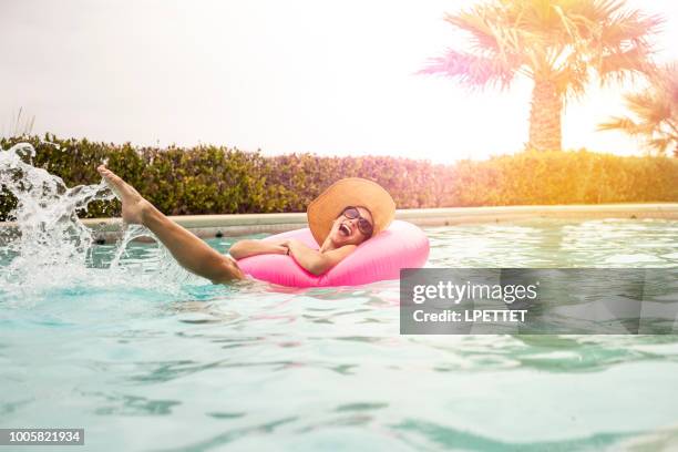 summer swimming pool fun - the tanning of america stock pictures, royalty-free photos & images