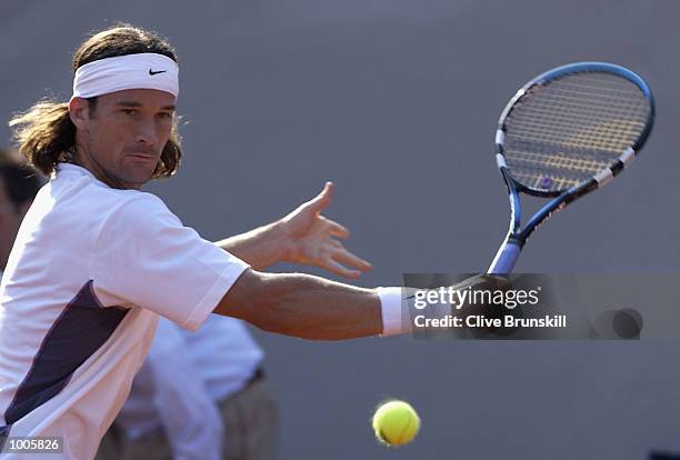 Carlos Moya of Spain plays a backhand during his second round match against Daniel Melo of Brazil during the Open Seat Godo 2002 held in Barcelona,...