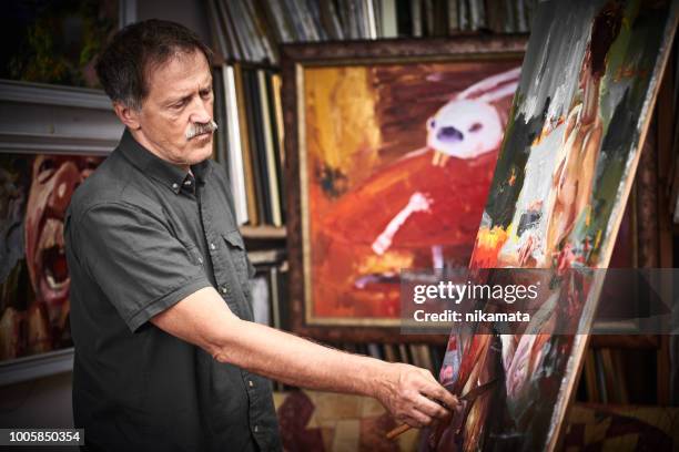 artist painting in art studio - pension ukraine stock pictures, royalty-free photos & images