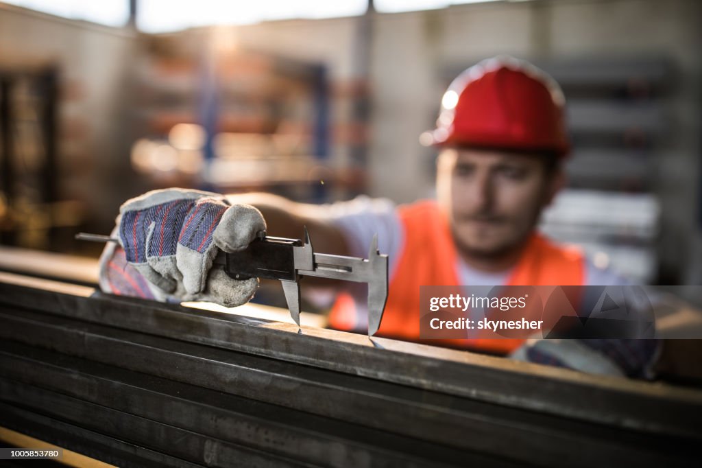 Close up of measuring steel with caliper.