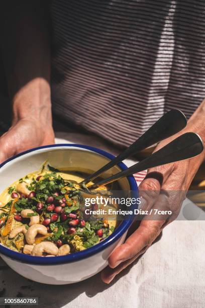 vegan curry laksa bowl, two hands - laksa imagens e fotografias de stock