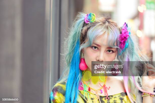 portrait of unique-looking young woman in colourful clothes - blue hair stock pictures, royalty-free photos & images