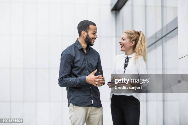 business people discussing in front of building - convention center outside stock pictures, royalty-free photos & images