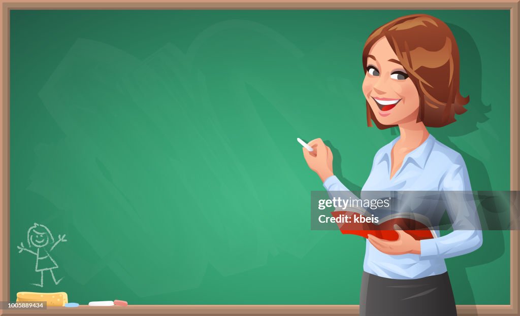 Female Teacher Writing On Blackboard
