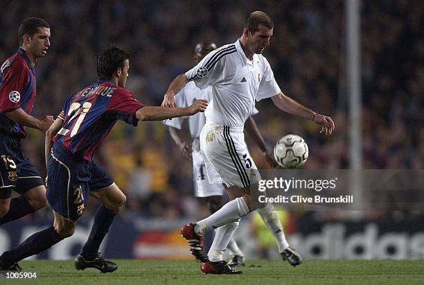 Zinedine Zidane of Real Madrid is pursued by Luis Enrique of Barcelona during the UEFA Champions League Semi Final First Leg match between Barcelona...