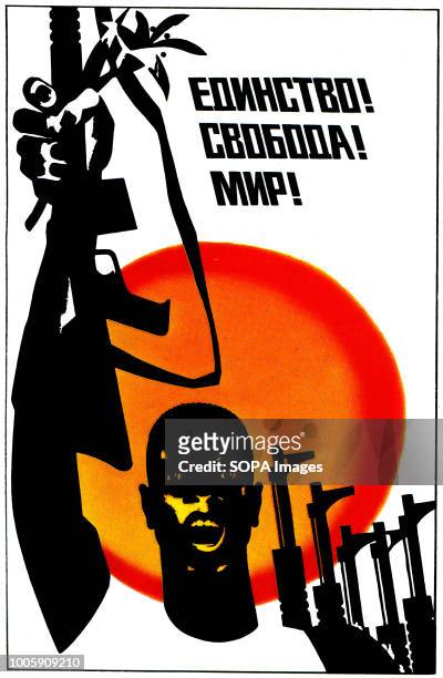 Vintage soviet poster, published in Moskow, 1970s - 1980s. Poster with text Unity! Freedom! Peace! shows a black man holding over the head with a...