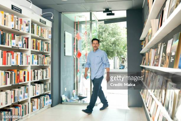 new customer entering a library - entering shop stock pictures, royalty-free photos & images