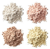 Four various heaps of protein powder (vanilla, strawberry, chocolate, banana)