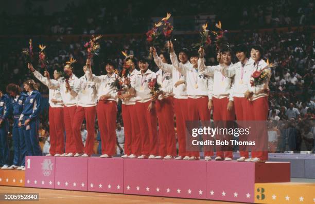 View of the China female volleyball team standing together on the medal podium after finishing in first place to win the gold medal in the Women's...