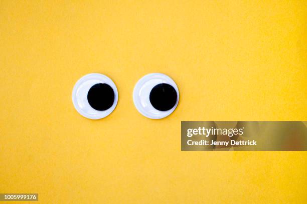 googly eyes on yellow - googly eyes stock pictures, royalty-free photos & images