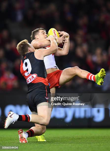 Tom Papley of the Swans marks infront of Brendon Goddard of the Bombers during the round 19 AFL match between the Essendon Bombers and the Sydney...