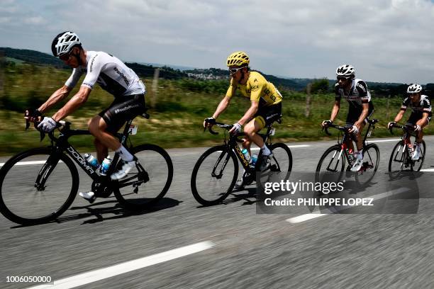 Great Britain's Christopher Froome, Great Britain's Geraint Thomas, wearing the overall leader's yellow jersey and Netherlands' Laurens ten Dam ride...