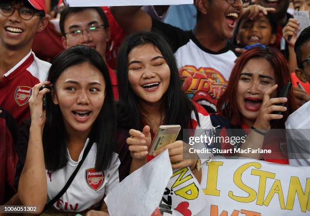 Arsenal fans in tears after meeting Mesut Ozil during a training session at the Singapore National Stadium on July 27, 2018 in Singapore.