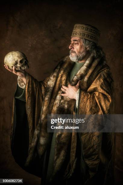 hamlet by william shakespear holding skull in his hands - hamlet character stock pictures, royalty-free photos & images