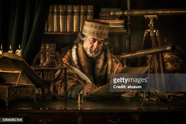 astronomer writing on parchment with feather pen - ancient stock pictures, royalty-free photos & images