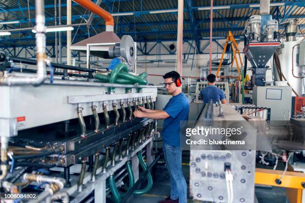 people at work. industrial manufacture indoors. - cnc stock pictures, royalty-free photos & images