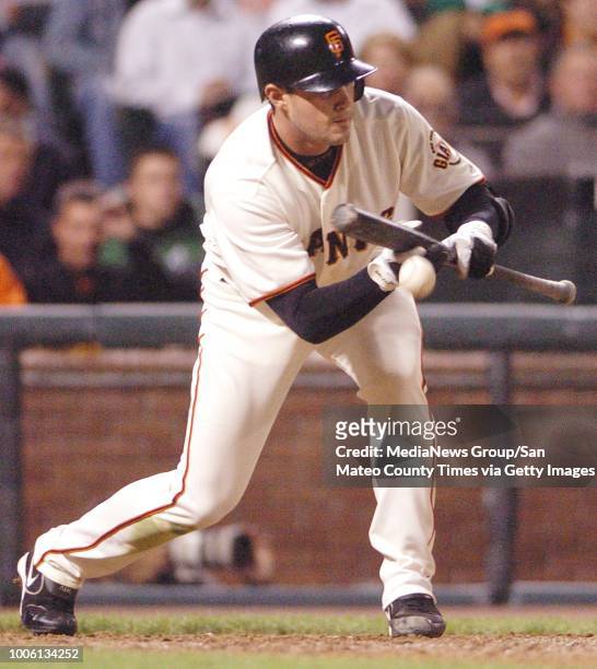 Ron lewis/staff 8.21.06 san mateo county times&#10;&#13;San Francisco Giants pitcher Noah Lowry hits a sacrifice bunt and is safe at 1st after an...
