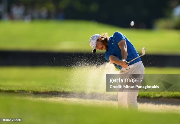Tommy Fleetwood of England plays a shot from a bunker on the 13th hole during the second round at the RBC Canadian Open at Glen Abbey Golf Club on...