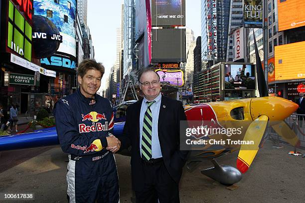 Kirby Chambliss, Red Bull Air Race pilot shakes hands with Jerramiah T. Healy, Mayor of Jersey City at an event in Times Square to announce the June...