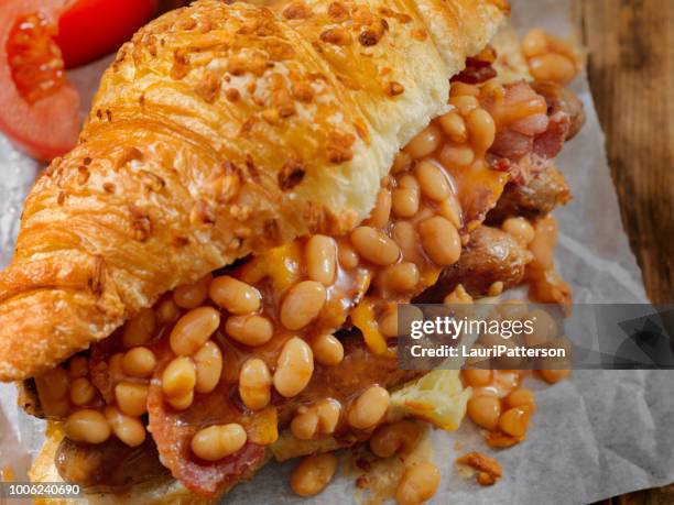 full english breakfast croissant sandwich - baked beans stock pictures, royalty-free photos & images
